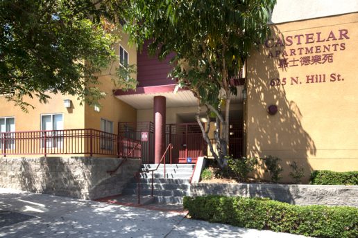 Castelar Apartments with 625 N Hill St on exterior, double staircase, and sidewalk